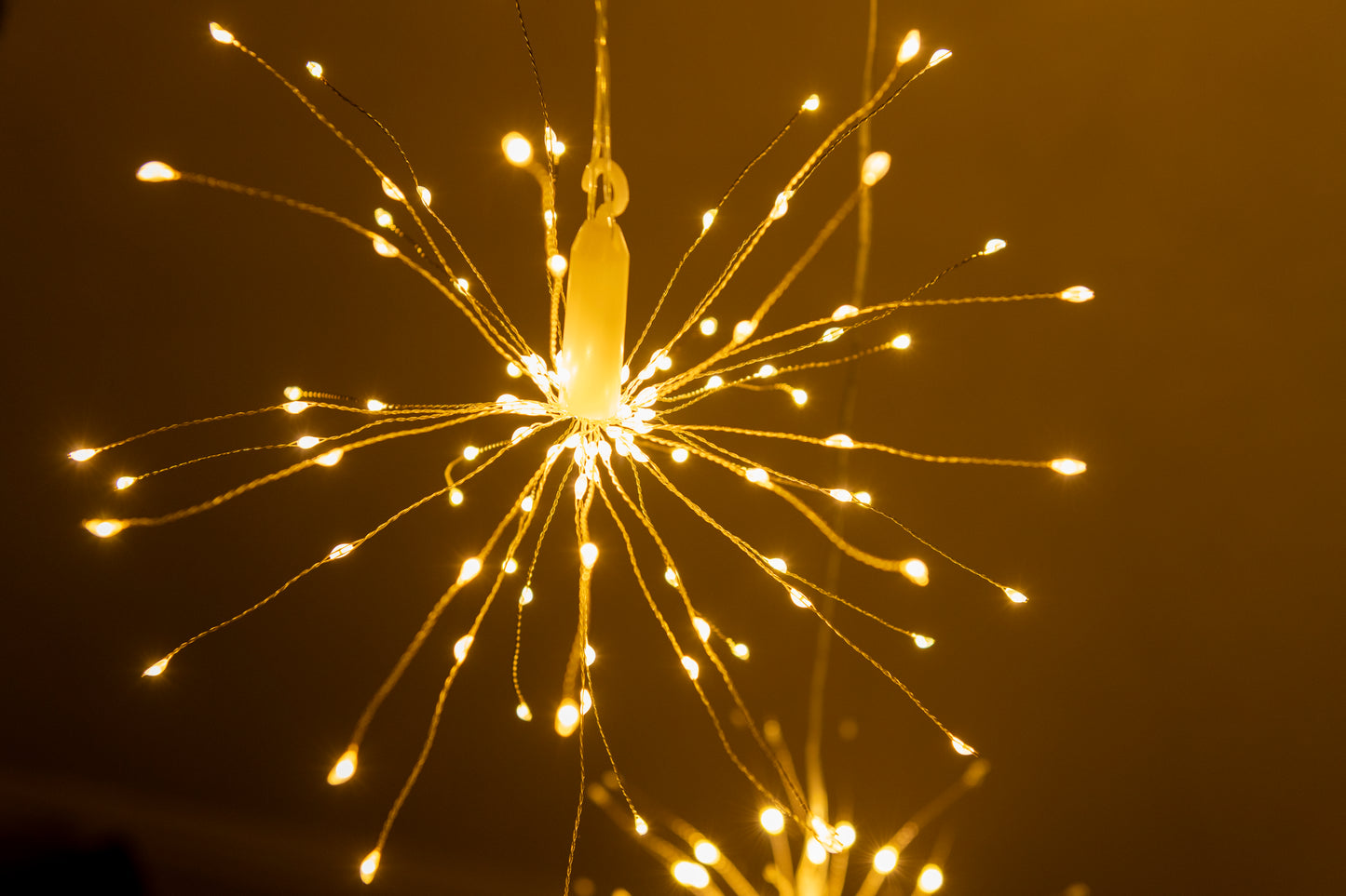 Hanging firework light warm light ornament. Battery operated use inside or outside.