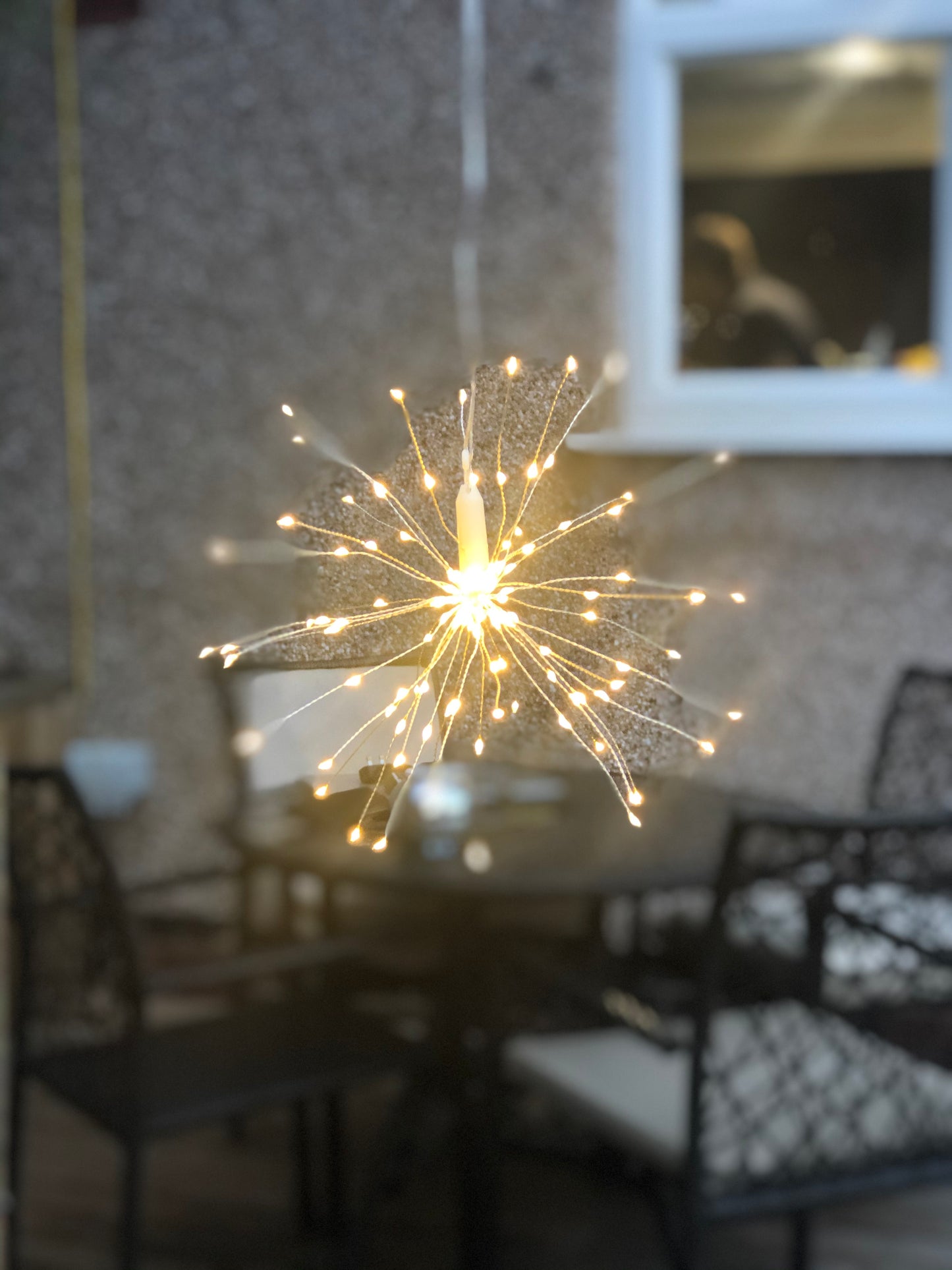 Hanging firework light warm light ornament. Battery operated use inside or outside.