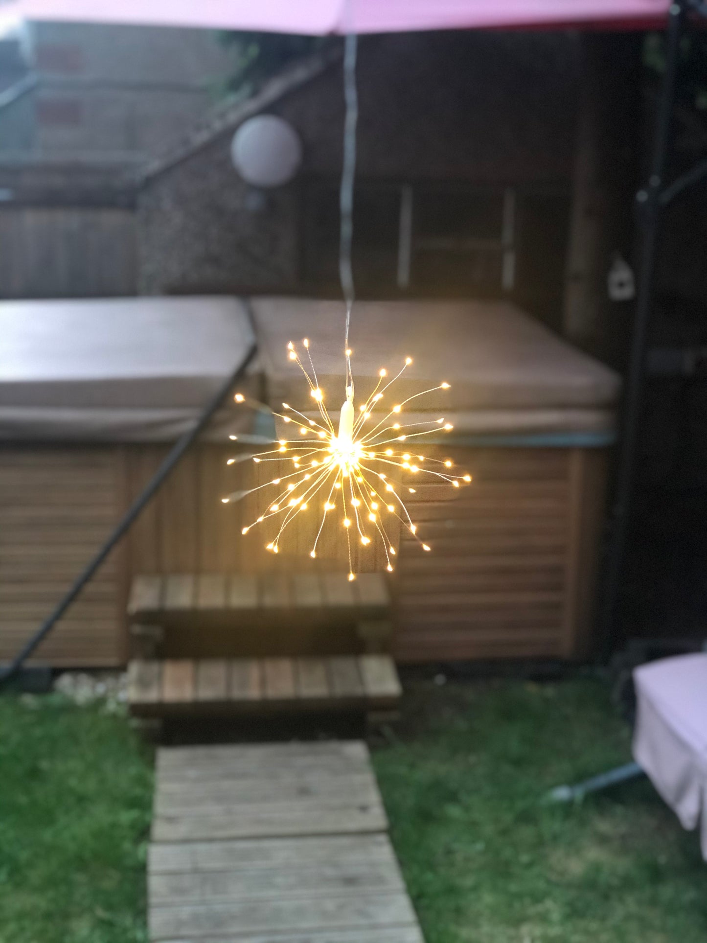 Hanging firework light warm light ornament. Battery operated use inside or outside.
