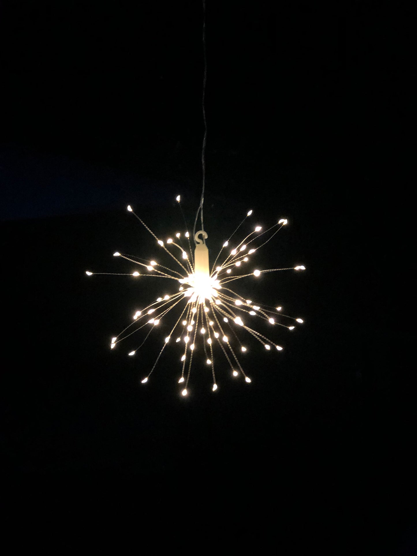 Hanging firework light warm light ornament. Battery operated use inside or outside.