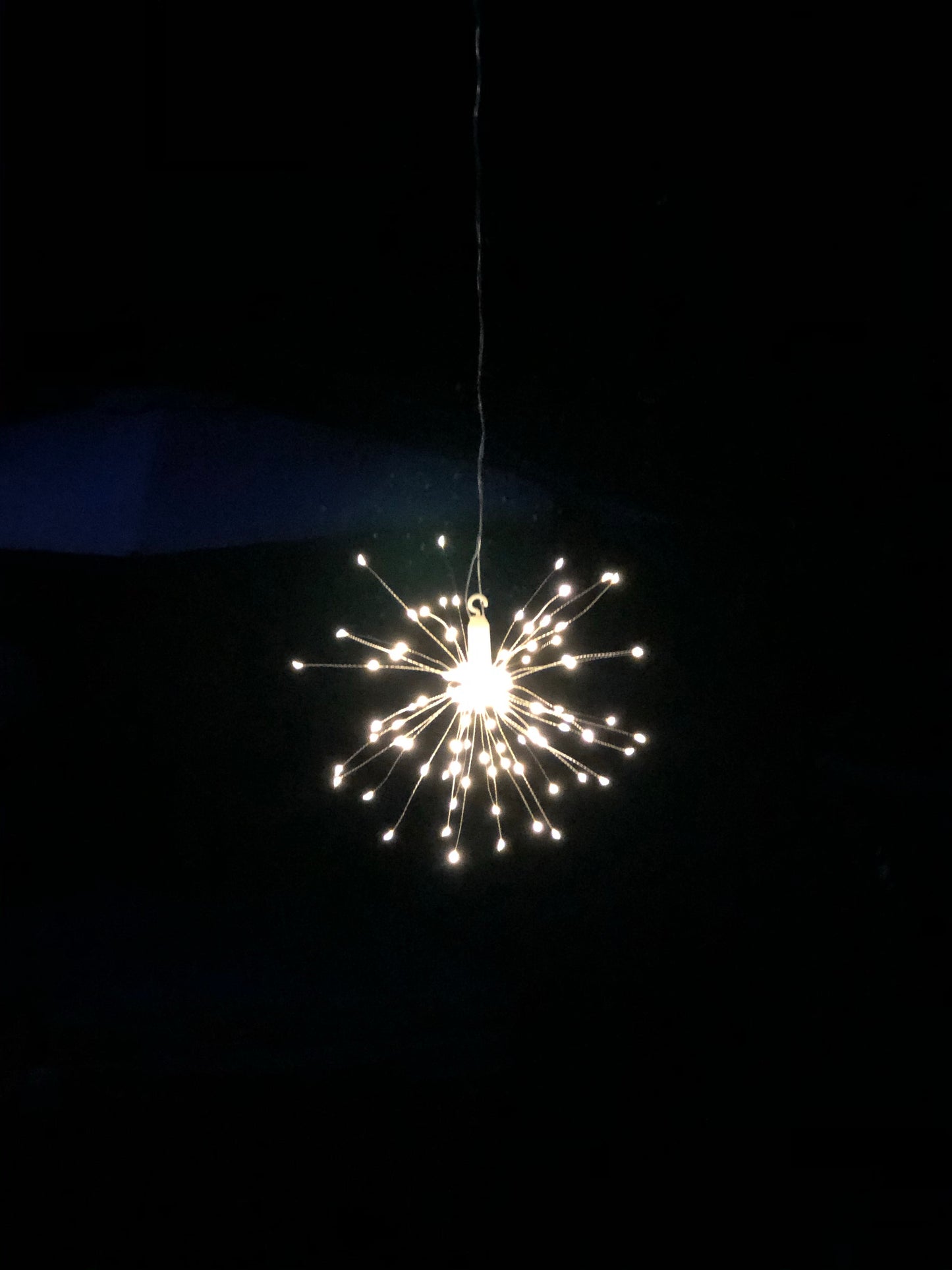 Hanging firework light warm light ornament. Battery operated use inside or outside.