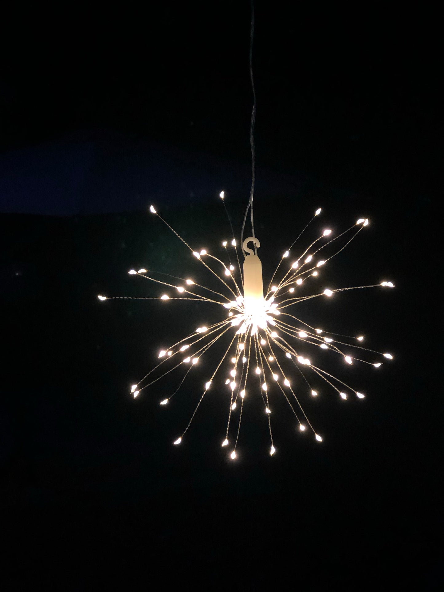 Hanging firework light warm light ornament. Battery operated use inside or outside.