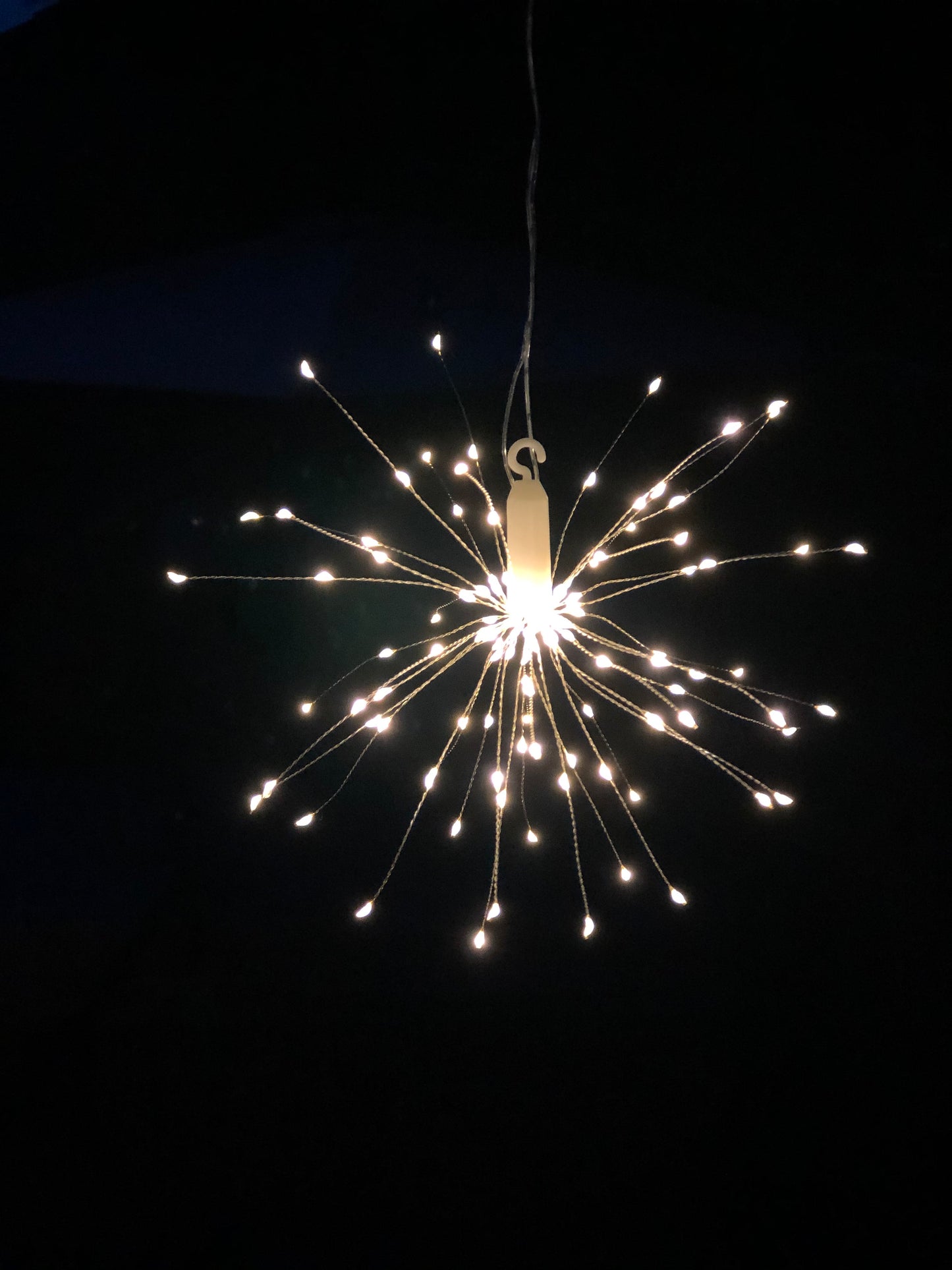 Hanging firework light warm light ornament. Battery operated use inside or outside.