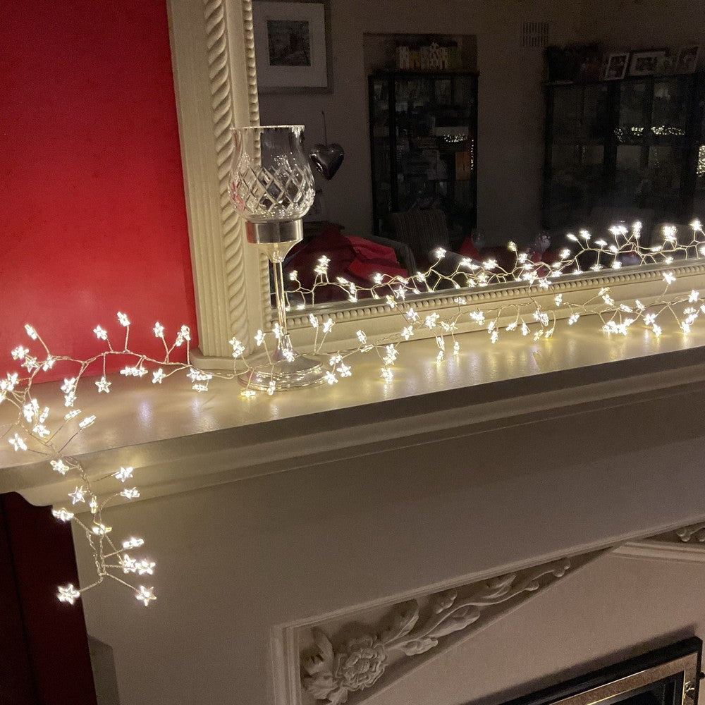Warm white star cluster lights decorating a mantelpiece