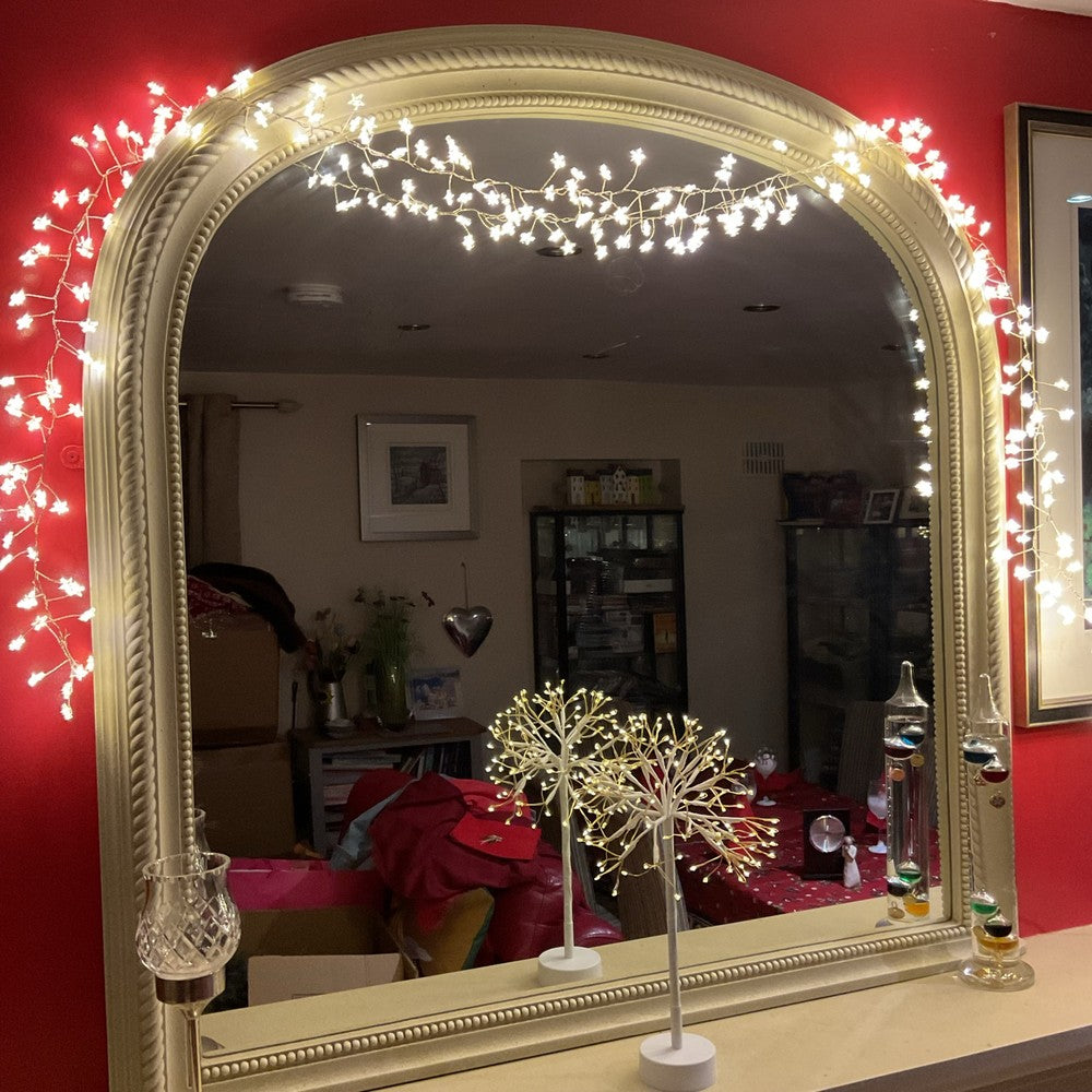 Warm white LED star Christmas lights around a mirror