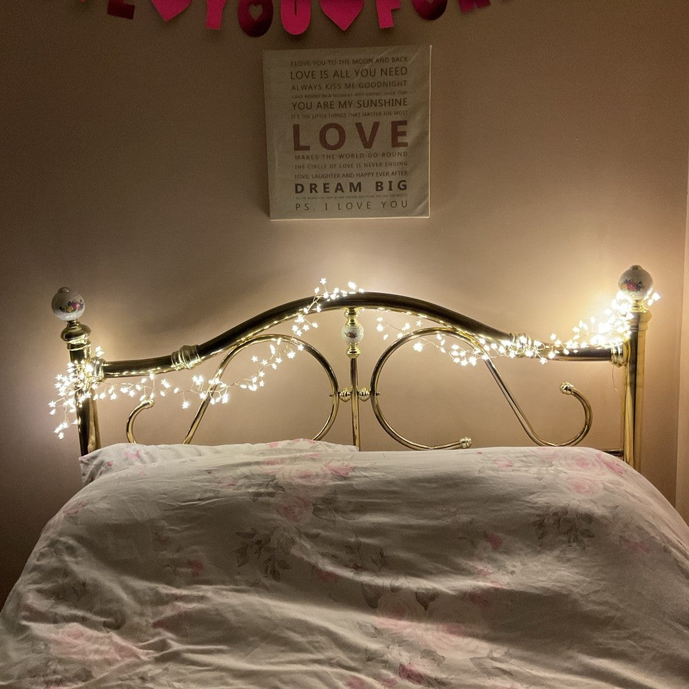 Warm white star cluster lights decorating a bedroom