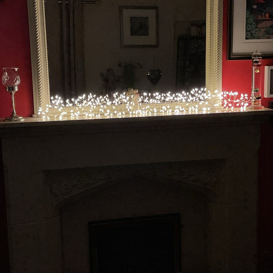 1.2m 240 LED warm white star cluster Christmas lights on mantel