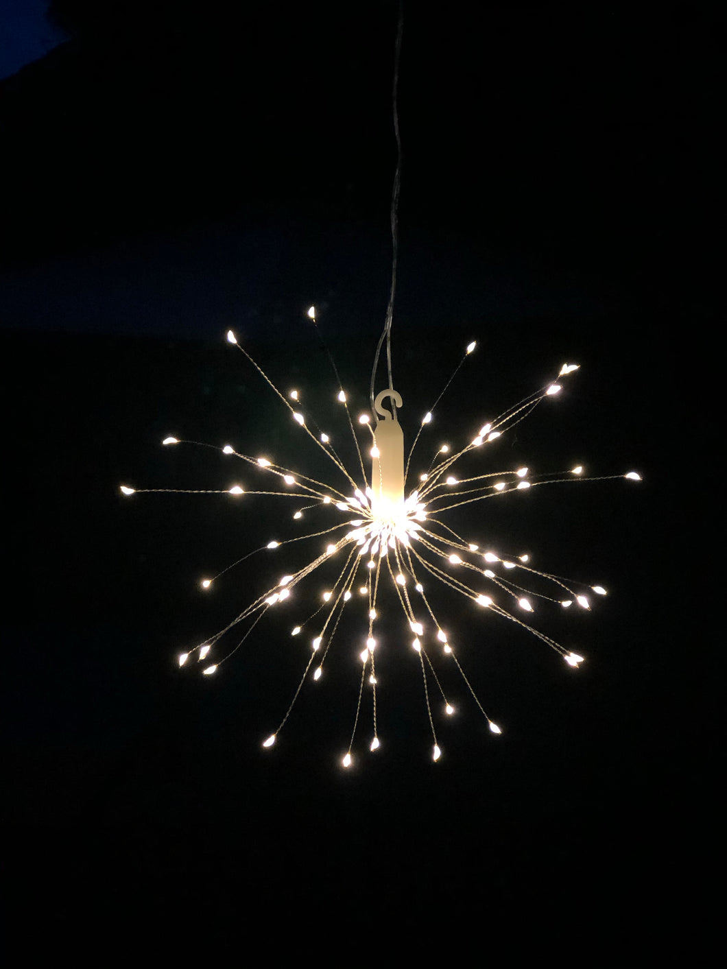 Hanging firework light warm light ornament. Battery operated use inside or outside.